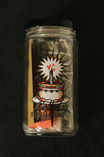 Load image into Gallery viewer, A clear glass jar with a black lid, containing 1 soy taper candle, sage and sweetgrass bundles, matchbook, salt, and crystal, and printed with a birthday cake illustration with the text 'Birthday - Your Solar Return.' The jar is photographed on a dark, textured background.
